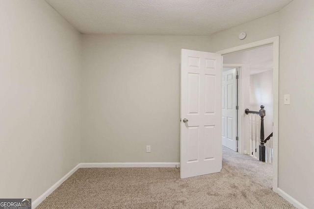 5352 Windfern Ct, Stone Mountain, GA 30088 - carpeted empty room featuring baseboards, a smoke detector, and a textured ceiling