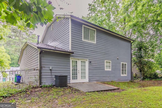 5352 Windfern Ct, Stone Mountain, GA 30088 - rear view of house featuring cooling unit, a patio area, a lawn, and french doors