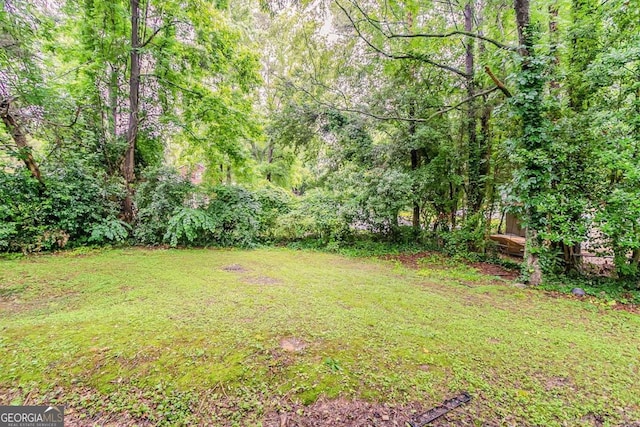 5352 Windfern Ct, Stone Mountain, GA 30088 - view of green lawn featuring a wooded view