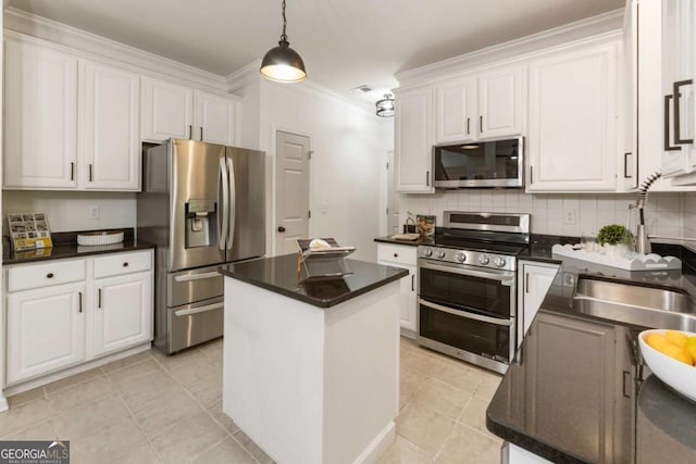 5860 Fairway View Dr, Suwanee, GA 30024 - kitchen with appliances with stainless steel finishes, white cabinets, dark countertops, a kitchen island, and ornamental molding