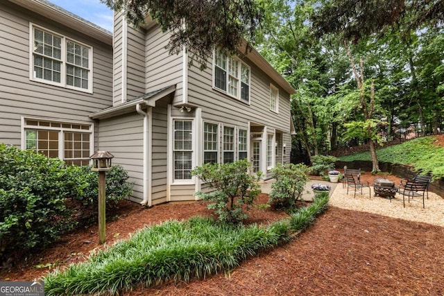 5860 Fairway View Dr, Suwanee, GA 30024 - view of property exterior with an outdoor fire pit and a patio