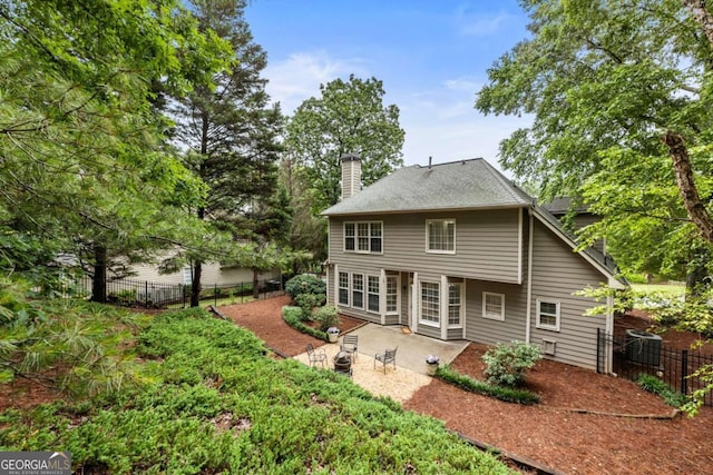 5860 Fairway View Dr, Suwanee, GA 30024 - rear view of house with a chimney and a patio area
