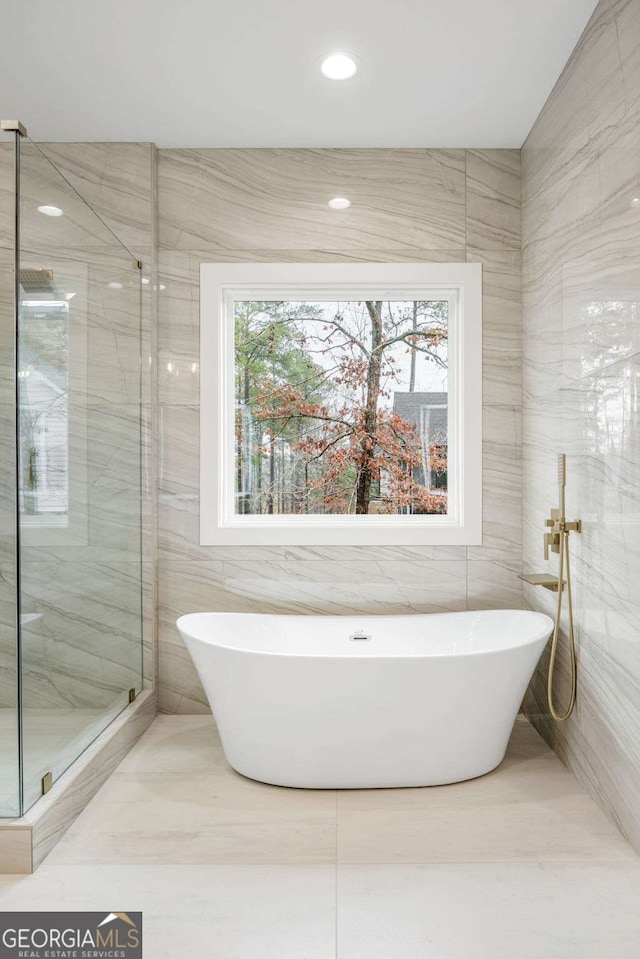 1050 Carnoustie, Greensboro, GA 30642 - full bathroom with tile walls, a marble finish shower, a freestanding tub, and recessed lighting
