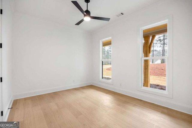 1050 Carnoustie, Greensboro, GA 30642 - empty room featuring light wood-style flooring, plenty of natural light, a ceiling fan, and ornamental molding