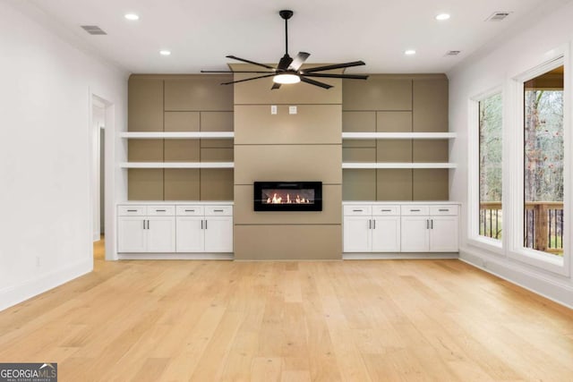 1050 Carnoustie, Greensboro, GA 30642 - unfurnished living room with light wood-style flooring, recessed lighting, built in features, a large fireplace, and a ceiling fan