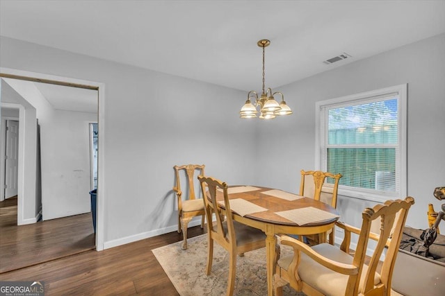 342 Chevis Rd, Savannah, GA 31419 - dining space with wood finished floors, a chandelier, and baseboards