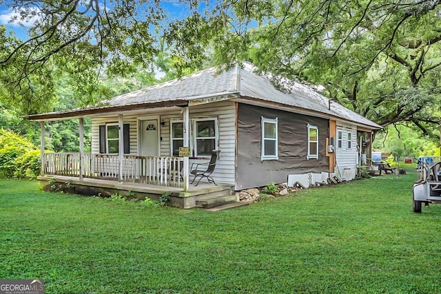 342 Chevis Rd, Savannah, GA 31419 - view of front facade featuring a porch, a front yard, and metal roof