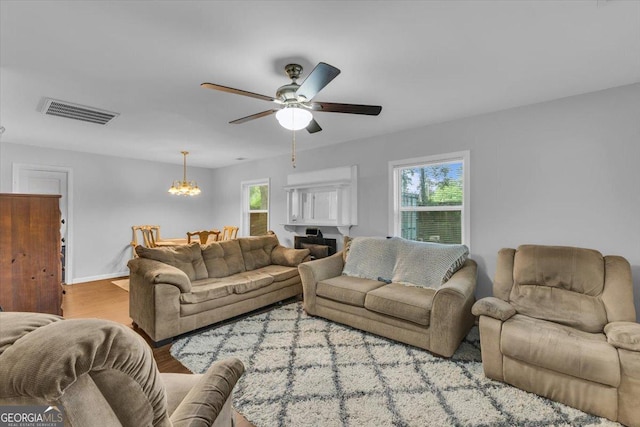 342 Chevis Rd, Savannah, GA 31419 - living area featuring a chandelier, wood finished floors, ceiling fan, and baseboards