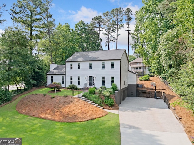 2885 Laurel Green Ct, Roswell, GA 30076 - colonial home with a front lawn and a chimney