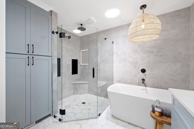 2885 Laurel Green Ct, Roswell, GA 30076 - bathroom featuring a shower stall, a freestanding bath, tile patterned floors, tile walls, and vanity