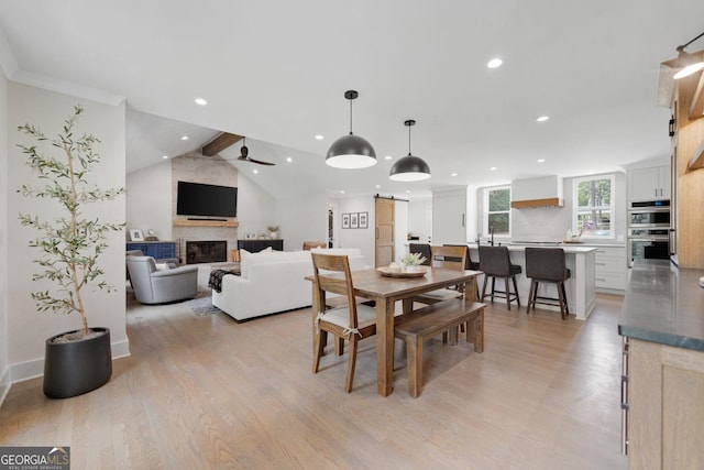 2885 Laurel Green Ct, Roswell, GA 30076 - dining area featuring a barn door, recessed lighting, a fireplace, light wood-style floors, and a ceiling fan