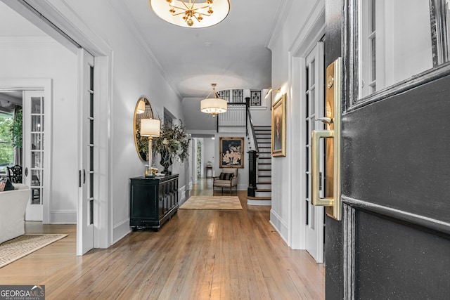 766 E Ave, Madison, GA 30650 - foyer entrance featuring stairway, hardwood / wood-style flooring, ornamental molding, and a chandelier