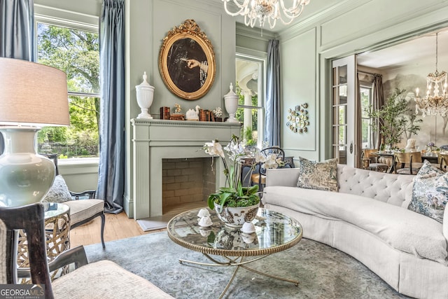 766 E Ave, Madison, GA 30650 - living room with a chandelier, wood finished floors, crown molding, and a fireplace