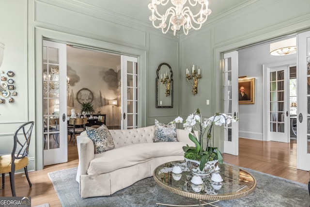 766 E Ave, Madison, GA 30650 - living area with a chandelier, french doors, crown molding, wood finished floors, and a decorative wall