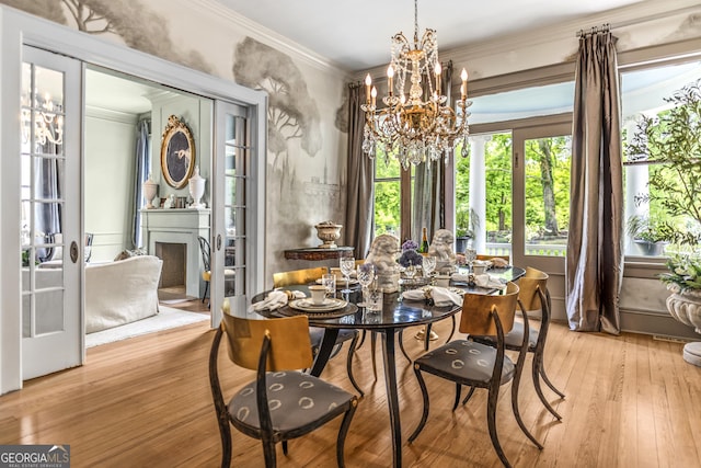 766 E Ave, Madison, GA 30650 - dining area featuring a chandelier, crown molding, a fireplace, and wood finished floors