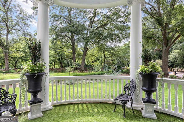 766 E Ave, Madison, GA 30650 - view of green lawn with covered porch and view of wooded area
