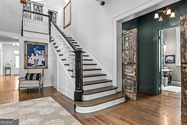 766 E Ave, Madison, GA 30650 - stairs featuring hardwood / wood-style floors and a high ceiling