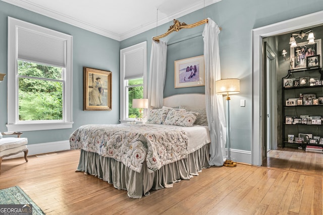 766 E Ave, Madison, GA 30650 - bedroom featuring hardwood / wood-style flooring and ornamental molding