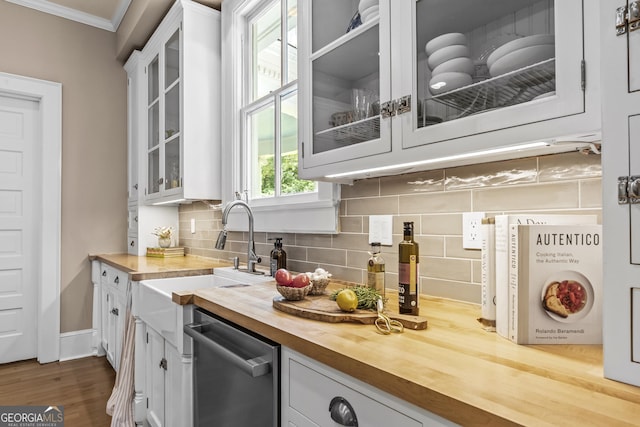 766 E Ave, Madison, GA 30650 - kitchen featuring wood counters, dishwasher, ornamental molding, white cabinets, and tasteful backsplash