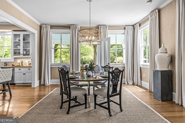 766 E Ave, Madison, GA 30650 - dining area with a chandelier, wood finished floors, and bar area