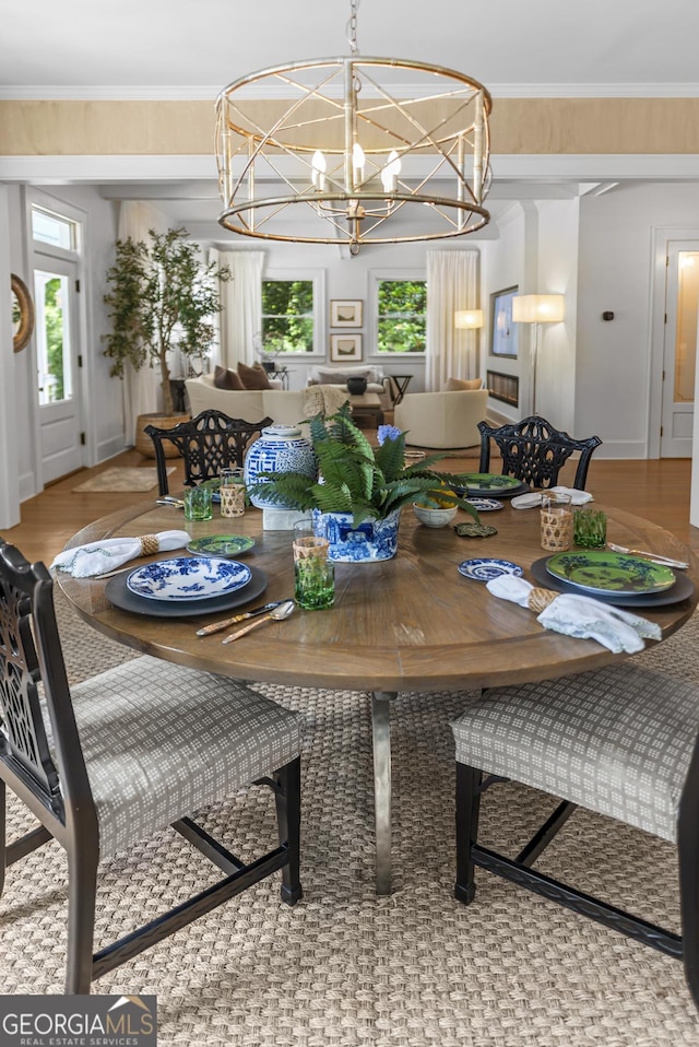 766 E Ave, Madison, GA 30650 - dining area with healthy amount of natural light, a chandelier, and crown molding
