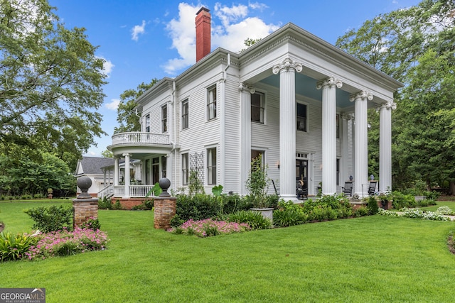 766 E Ave, Madison, GA 30650 - view of front of property featuring a porch, a chimney, a front lawn, and a balcony