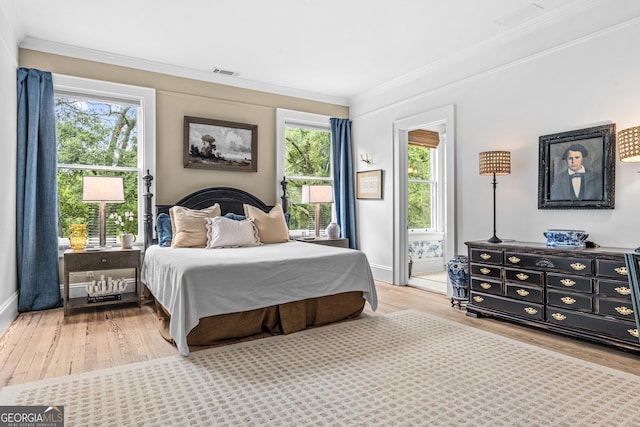 766 E Ave, Madison, GA 30650 - bedroom featuring wood finished floors, multiple windows, and ornamental molding