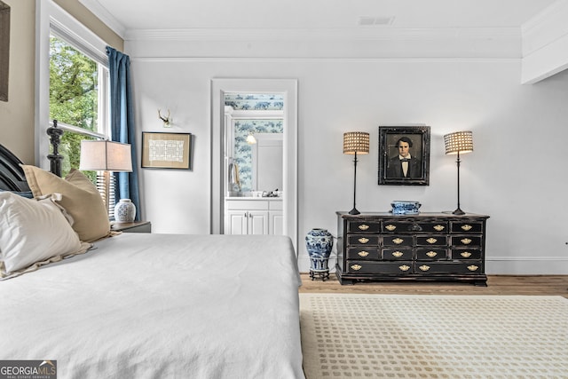 766 E Ave, Madison, GA 30650 - bedroom featuring crown molding, wood finished floors, and ensuite bath