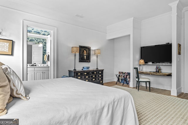 766 E Ave, Madison, GA 30650 - bedroom featuring crown molding, wood finished floors, and ensuite bath
