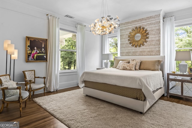 766 E Ave, Madison, GA 30650 - bedroom featuring ornamental molding, a chandelier, and dark wood-style floors