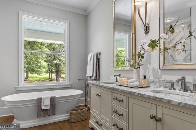 766 E Ave, Madison, GA 30650 - bathroom featuring double vanity, plenty of natural light, a soaking tub, wood finished floors, and crown molding