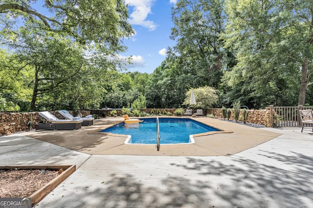 766 E Ave, Madison, GA 30650 - view of swimming pool featuring a patio area, view of scattered trees, and outdoor lounge area