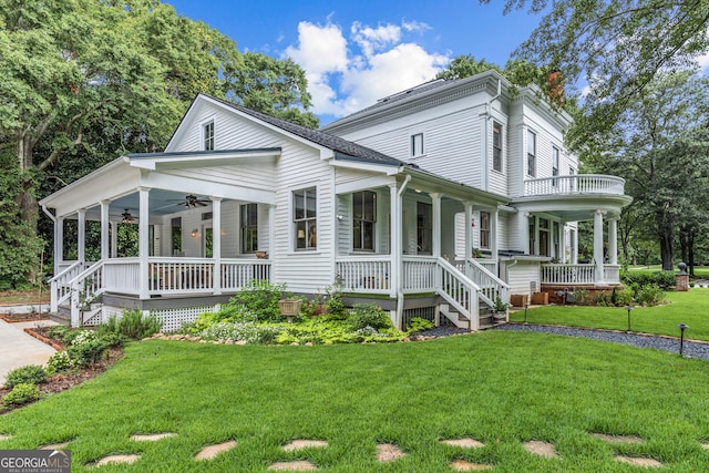 766 E Ave, Madison, GA 30650 - view of front facade with covered porch, a ceiling fan, and a front lawn