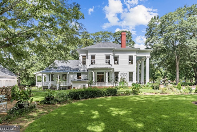 766 E Ave, Madison, GA 30650 - view of front of home with a chimney, a front yard, and a porch