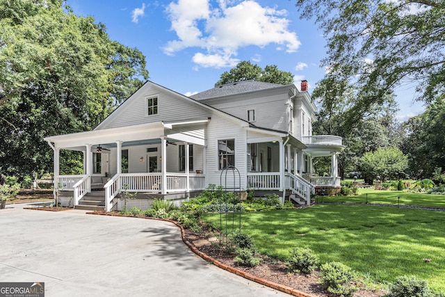 766 E Ave, Madison, GA 30650 - view of front of house with a porch, ceiling fan, a chimney, and a front yard