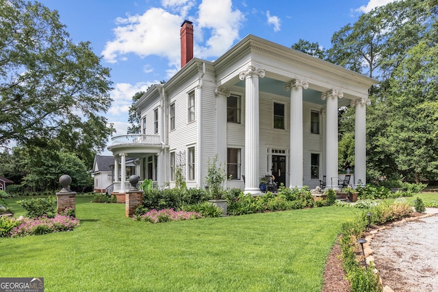 766 E Ave, Madison, GA 30650 - view of front facade with covered porch, a chimney, and a front yard