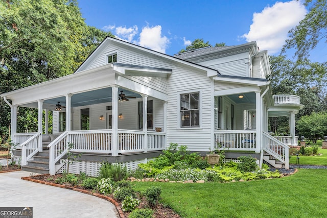 766 E Ave, Madison, GA 30650 - view of front facade with covered porch, a ceiling fan, a front yard, and stairs
