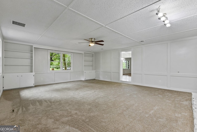 1124 Ponderosa Park Dr, Forest Park, GA 30297 - spare room with a decorative wall, built in features, a ceiling fan, and carpet flooring