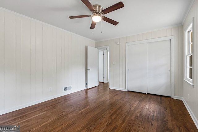 1124 Ponderosa Park Dr, Forest Park, GA 30297 - unfurnished bedroom with ornamental molding, wood finished floors, baseboards, a ceiling fan, and a closet