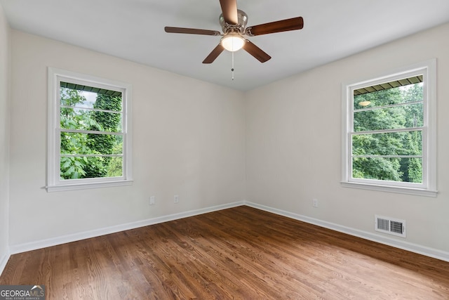 1124 Ponderosa Park Dr, Forest Park, GA 30297 - empty room featuring healthy amount of natural light, baseboards, wood finished floors, and a ceiling fan