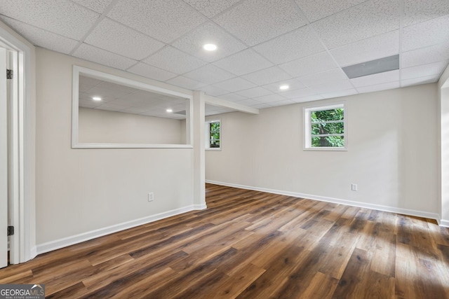 1124 Ponderosa Park Dr, Forest Park, GA 30297 - basement with dark wood-style flooring, baseboards, and a paneled ceiling