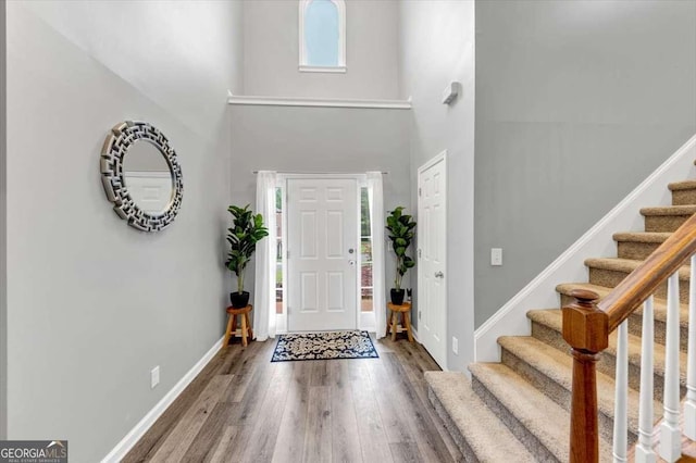 3190 Water Brook Dr SW, Conyers, GA 30094 - entryway with wood finished floors, stairway, a towering ceiling, and baseboards