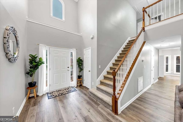 3190 Water Brook Dr SW, Conyers, GA 30094 - foyer featuring a high ceiling, wood finished floors, stairs, and baseboards