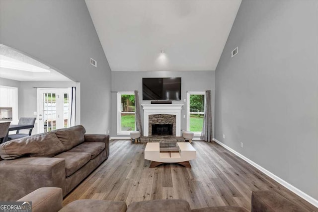 3190 Water Brook Dr SW, Conyers, GA 30094 - living room with high vaulted ceiling, wood finished floors, baseboards, and a fireplace