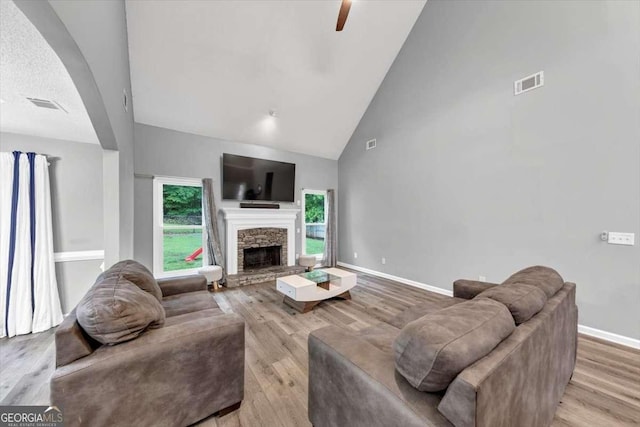 3190 Water Brook Dr SW, Conyers, GA 30094 - living area with wood finished floors, high vaulted ceiling, ceiling fan, baseboards, and a fireplace