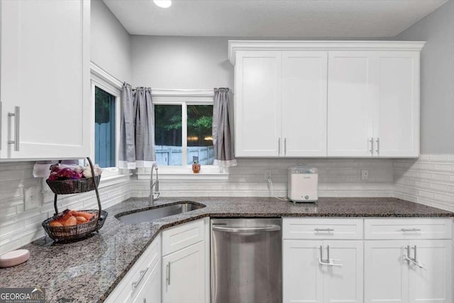 3190 Water Brook Dr SW, Conyers, GA 30094 - kitchen with stainless steel dishwasher, a sink, white cabinets, and dark stone countertops