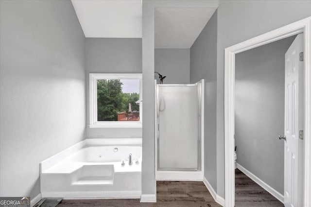 3190 Water Brook Dr SW, Conyers, GA 30094 - bathroom with a shower stall, a garden tub, wood finished floors, and toilet