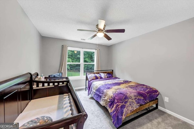 3190 Water Brook Dr SW, Conyers, GA 30094 - carpeted bedroom featuring a textured ceiling, baseboards, and a ceiling fan