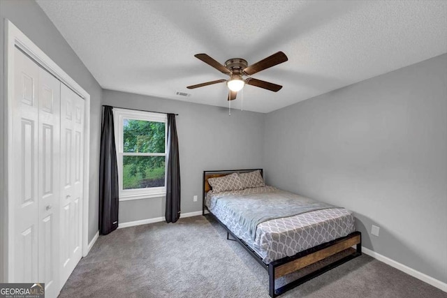 3190 Water Brook Dr SW, Conyers, GA 30094 - bedroom with a closet, carpet flooring, a textured ceiling, baseboards, and ceiling fan