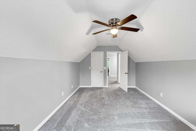 3190 Water Brook Dr SW, Conyers, GA 30094 - additional living space with a ceiling fan, baseboards, carpet, lofted ceiling, and a textured ceiling